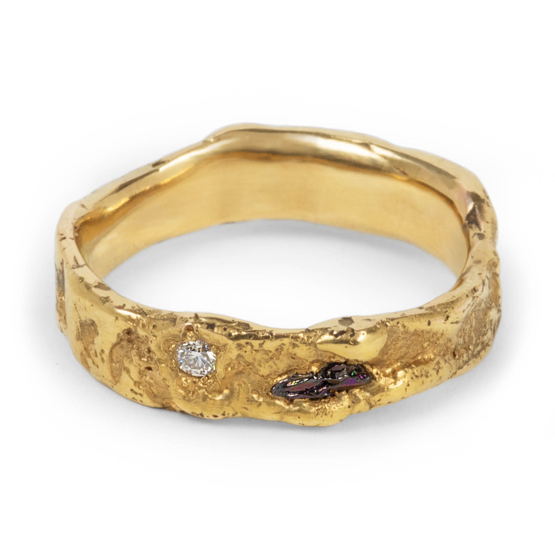 The Obsidian Ring in 9K, 14K, or 18K gold showing raw black and clear moissanite stones in a hand-textured band, artisan jewelry from Berlin