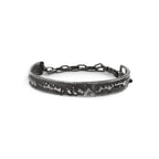 Silver cuff bracelet with texture and chain on a white background made in Berlin