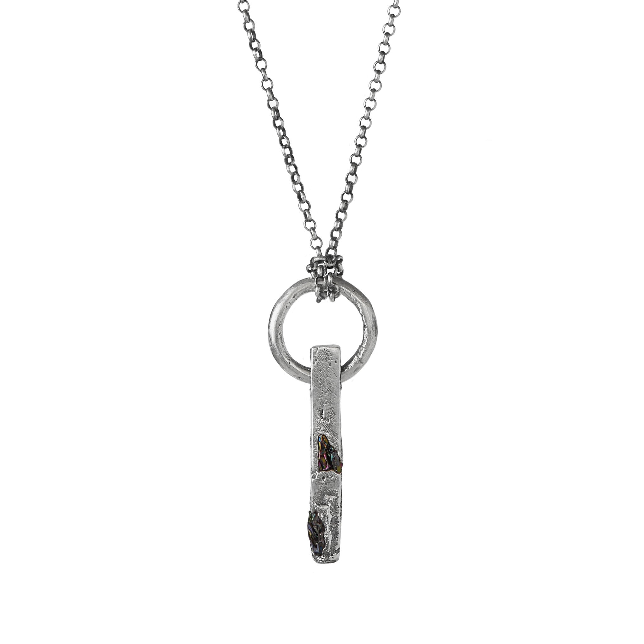 Handcrafted sterling silver necklace with sculptural bar pendant and suspended silver ring on a white background