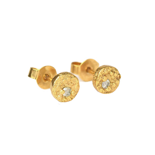 A pair of 24k gold plated sterling silver earrings with a yellow gold finish, featuring a central white moissanite diamond, set in a sandcast design.