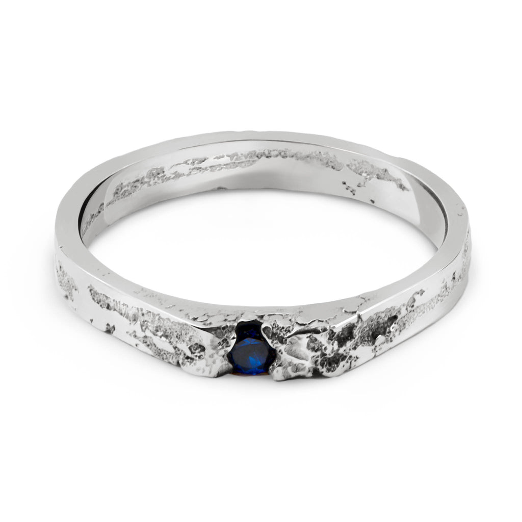 Handcrafted sterling silver ring with a blue gemstone from a Berlin based jewelry studio on a white background