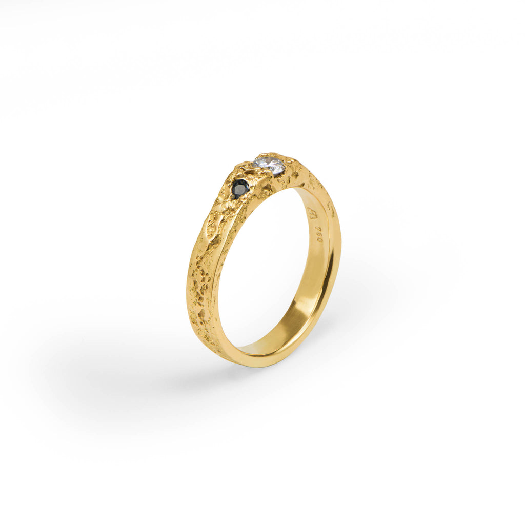 engagement ring in yellow gold with a clear diamond and two blue sapphires