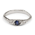 White gold ring with an organic texture and a blue sapphire handcrafted in Berlin