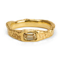 Flowing organic gold ring with a baguette cut champagne diamond