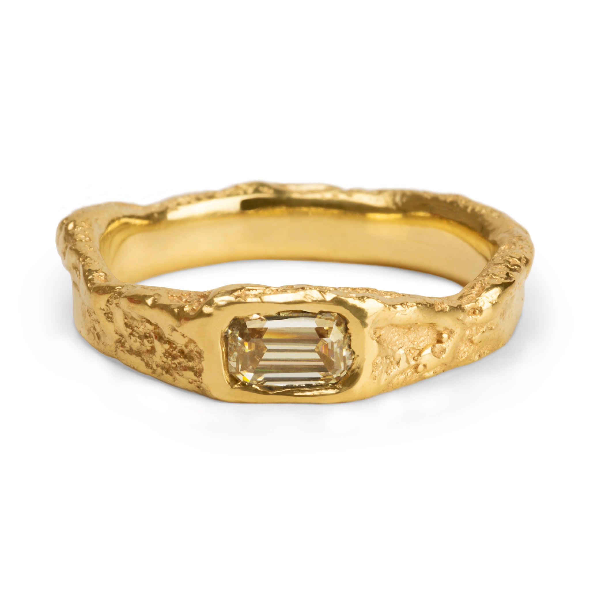 Flowing organic gold ring with a baguette cut champagne diamond