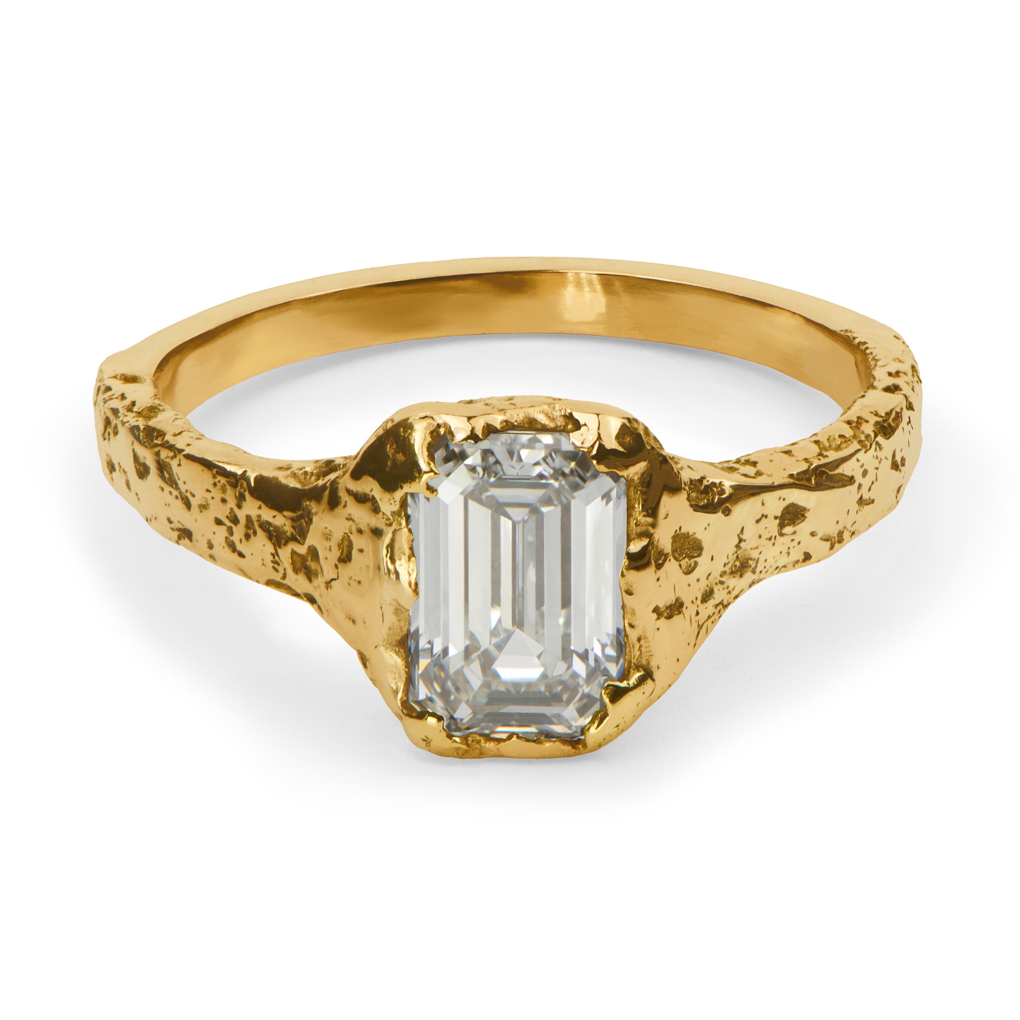 Gold ring with a rectangular diamond on a white background