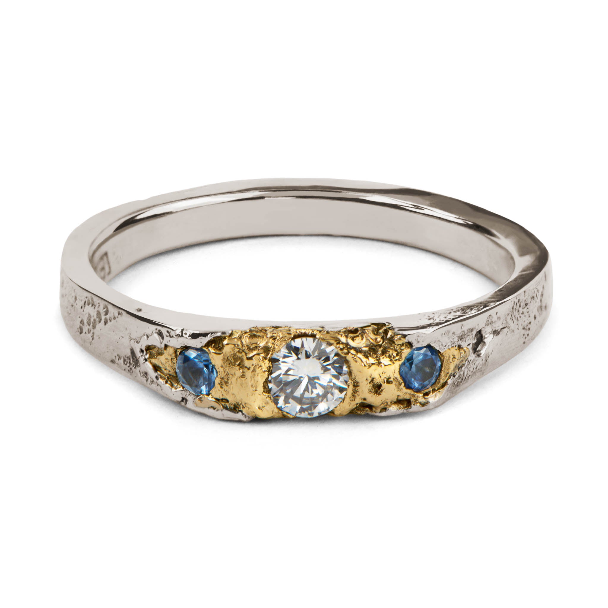 750 white gold ring with gold accents a diamond and two blue gemstones on a white background
