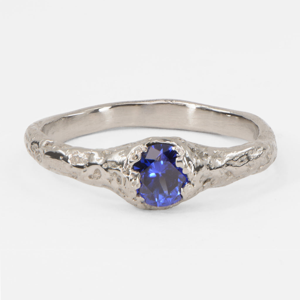 Handcrafted 750 white gold sapphire ring featuring a brilliant blue sapphire in an organic textured setting, contemporary alternative engagement ring with natural sculptural design