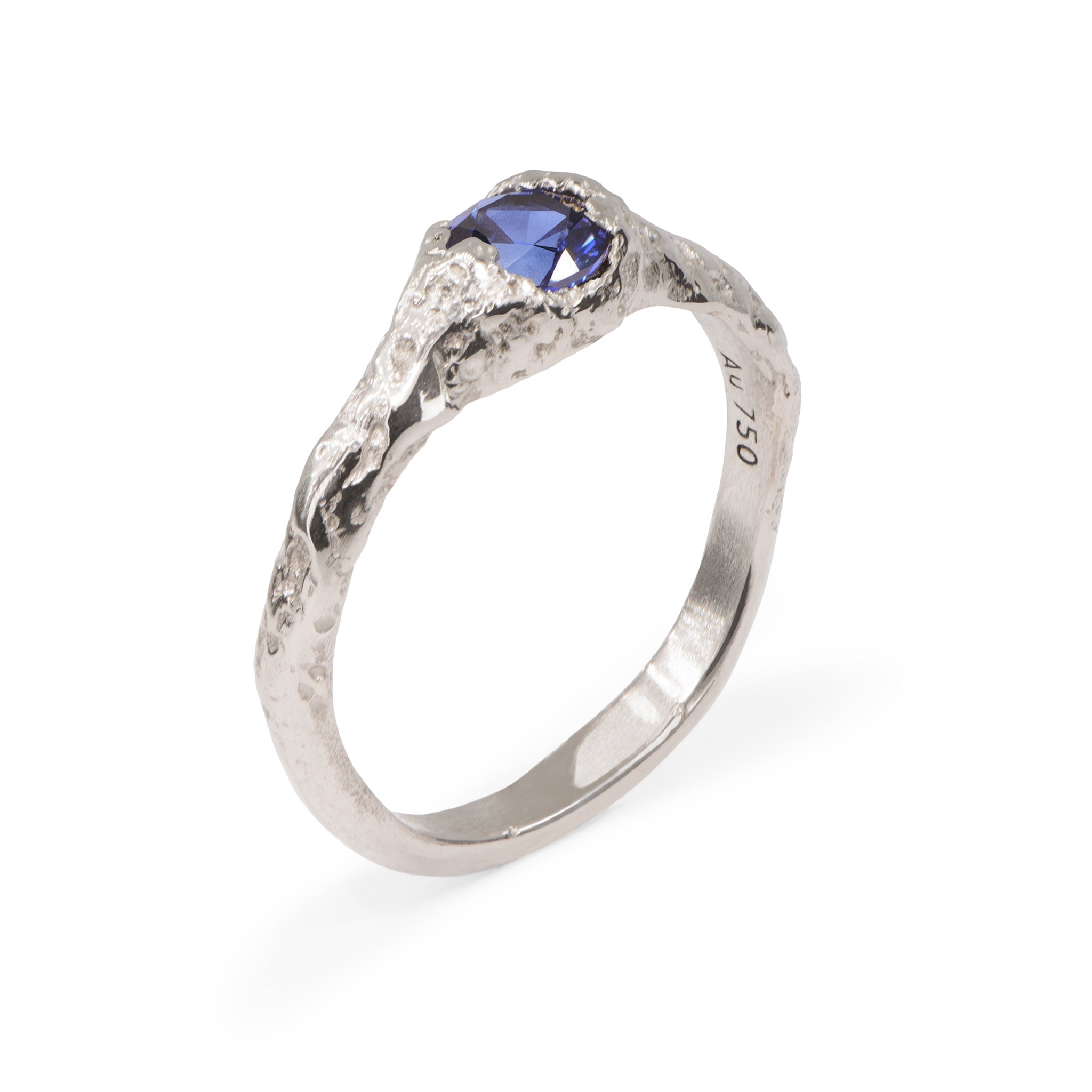 Blue sapphire set in an organic handcrafted white gold engagement ring