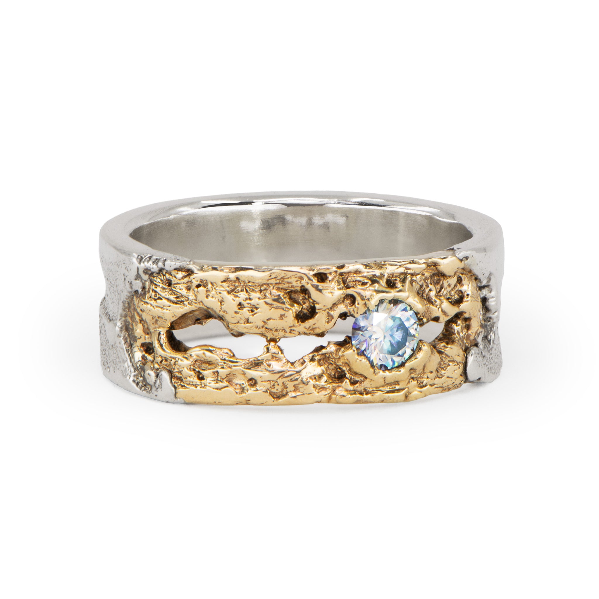 Textured two-tone ring with gold and silver design and a blue gemstone on a white background handcrafted in Berlin