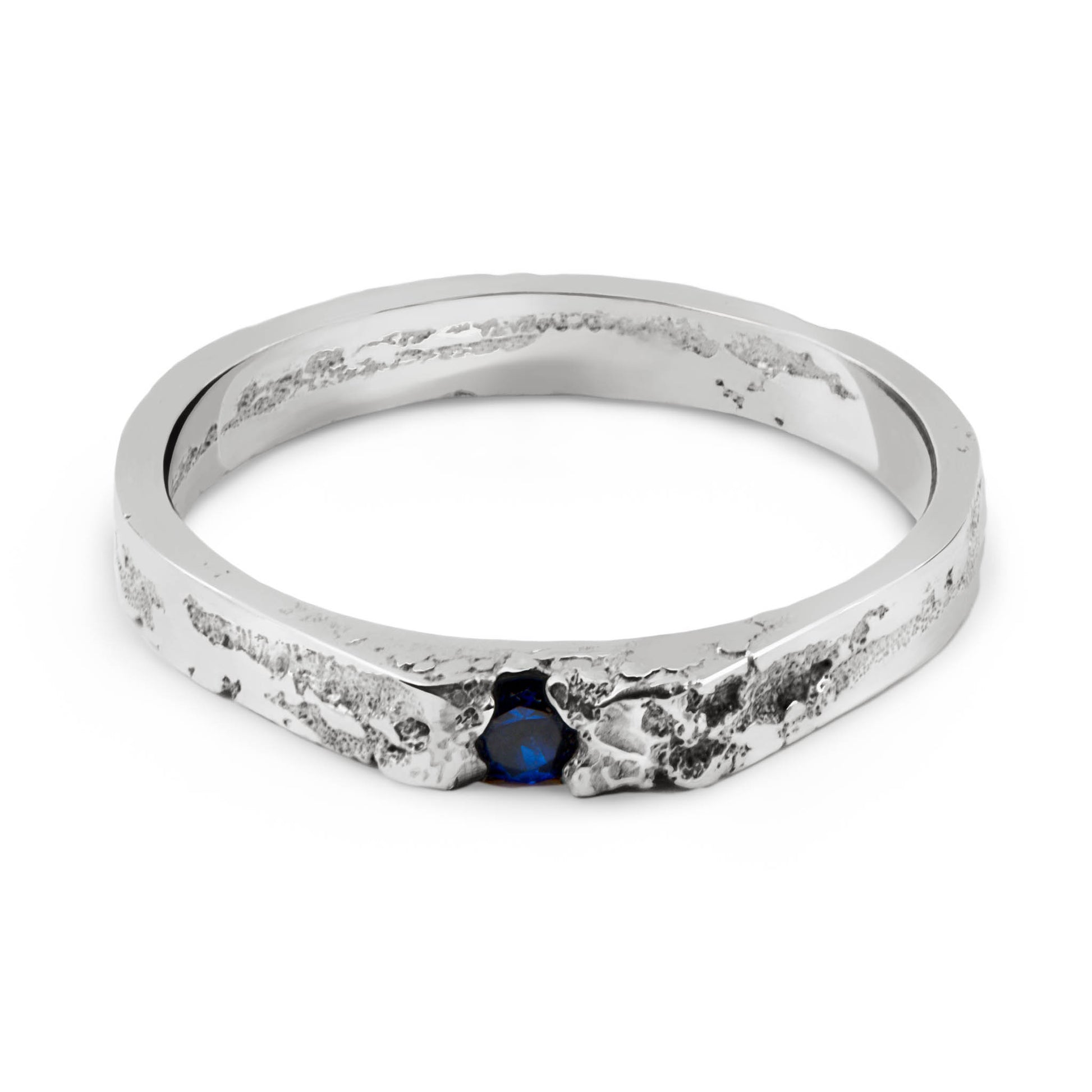 Silver ring with a blue gemstone on a white background