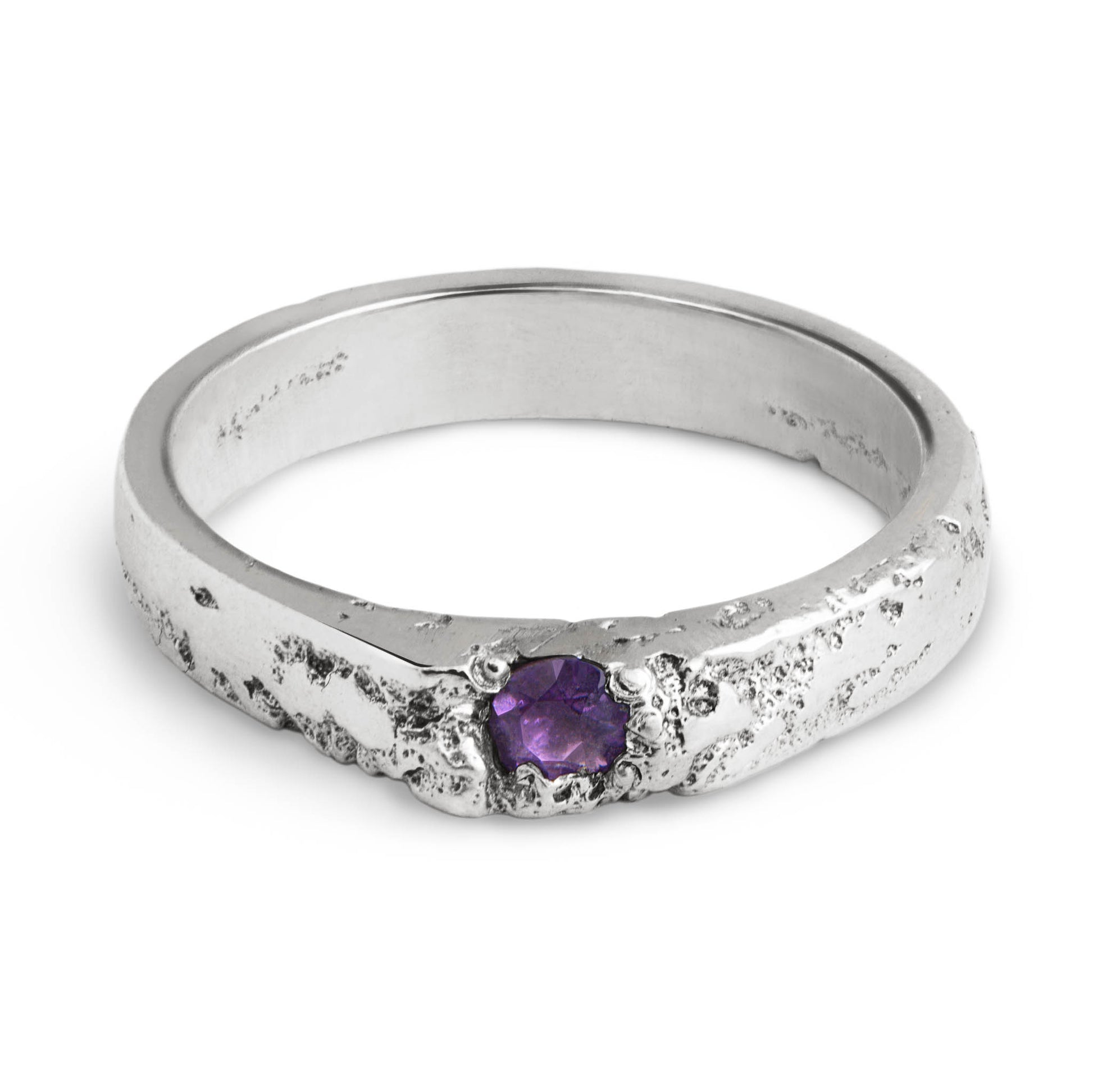 Silver ring with a purple gemstone on a white background