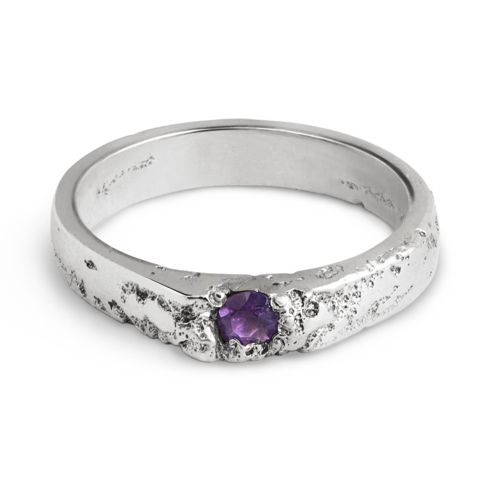 Handcrafted silver ring with a purple gemstone on a white background made in our Berlin jewelry studio.