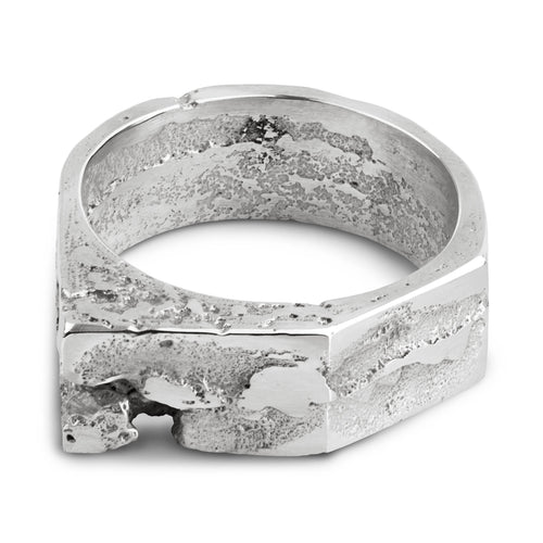 Sterling silver ring with a geometric design referencing brutalist architecture and a raw textured surface, handcrafted in our Berlin jewelry studio