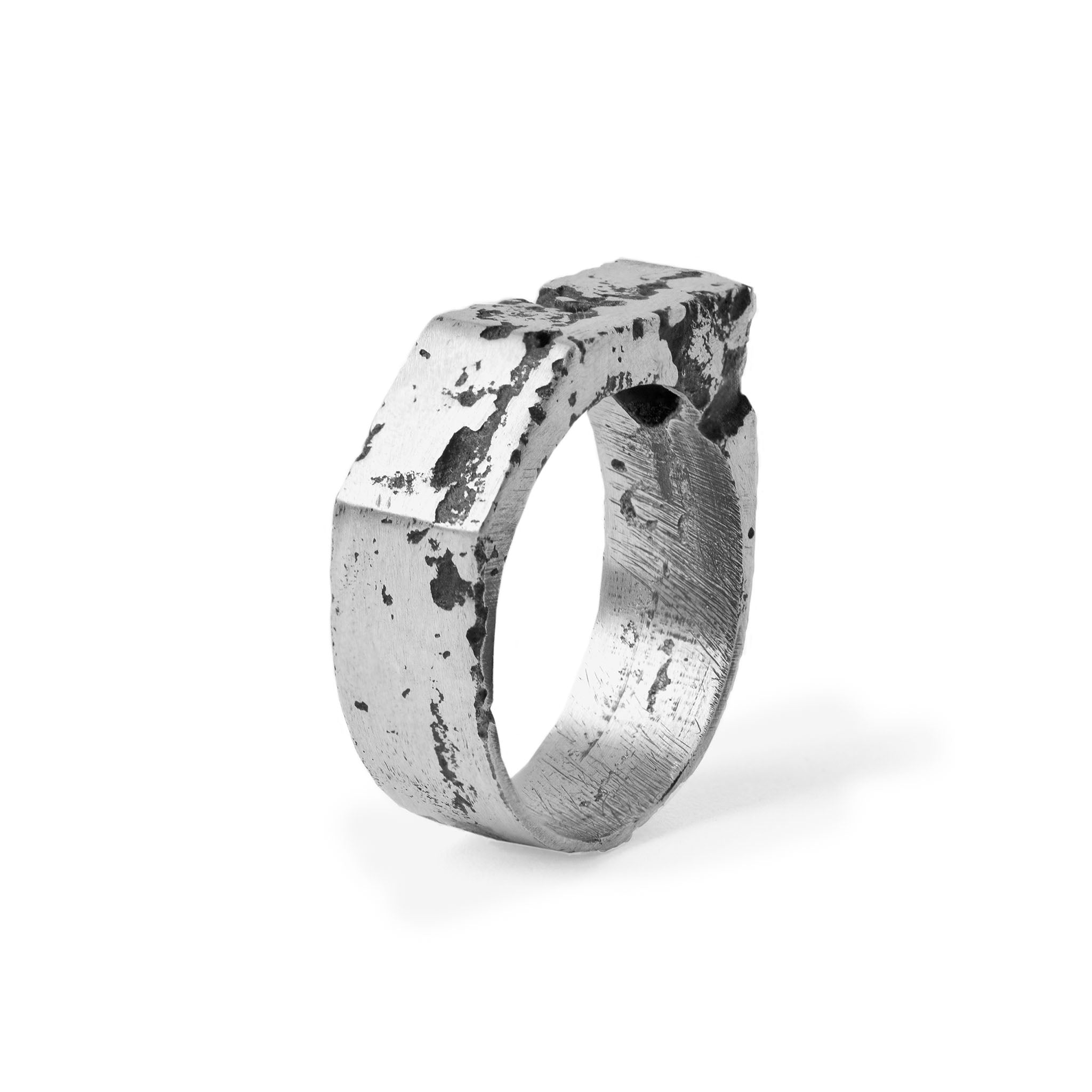 A oxidised silver ring with a textured surface, showcasing a handcrafted quality with slight imperfections.