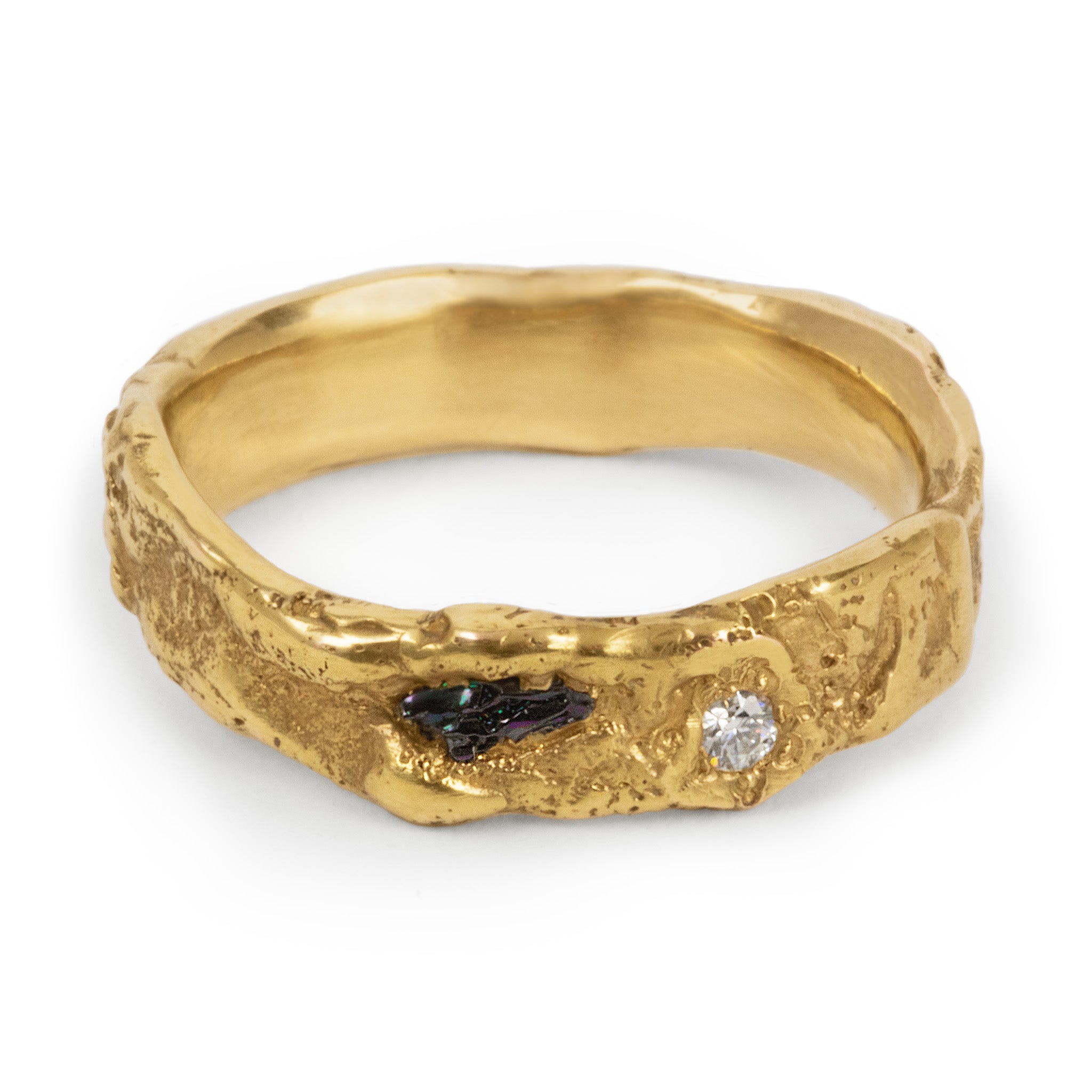 Gold ring with embedded stones on a white background