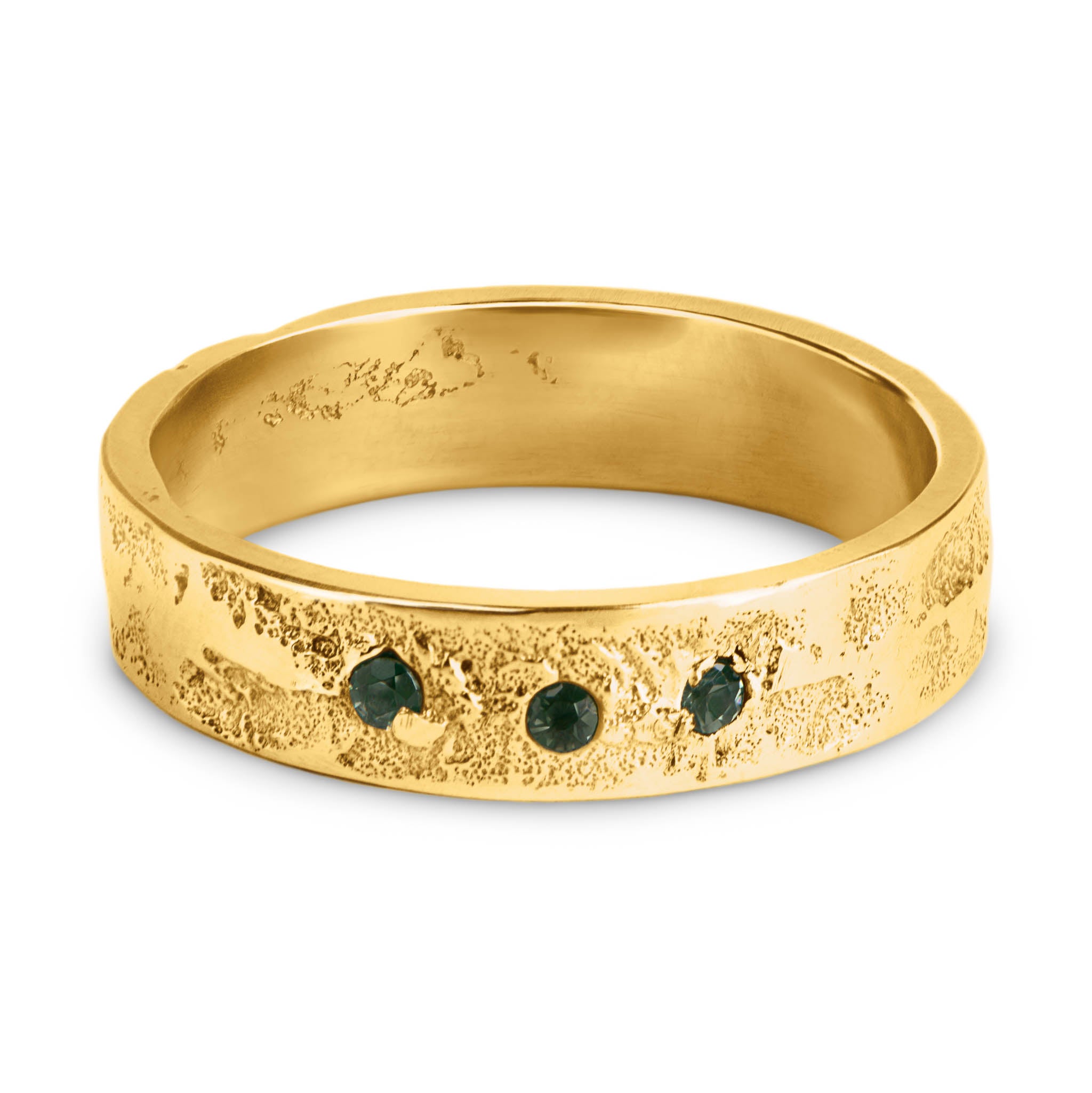 Gold ring with three green tourmalines and organic textured band on a white background.