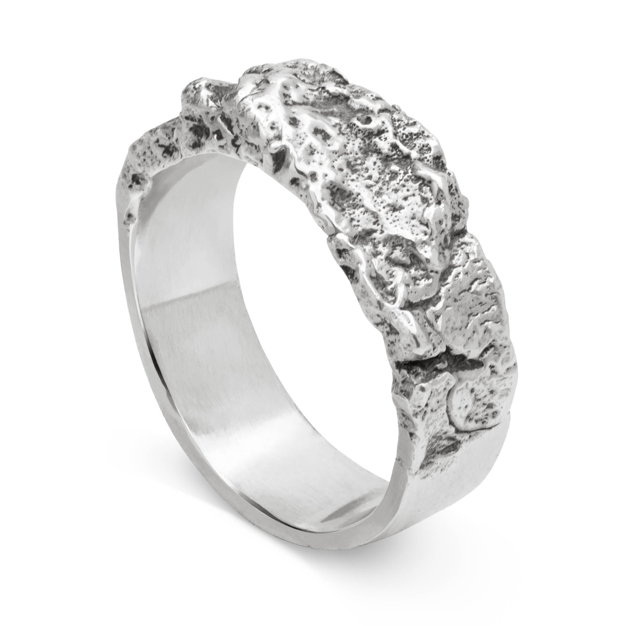 Sterling silver ring with a tree bark texture and a smooth finish inside handcrafted in our Berlin jewelry studio, standing on a white backrground.