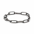 Handcrafted sterling silver link bracelet oxidised to highlight its handmade quality on a white background.