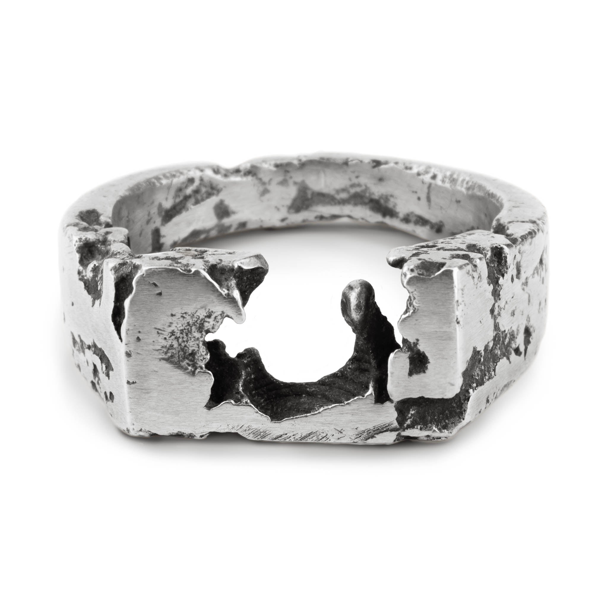 Oxidised sterling silver signet ring with raw textured 8 x 12 mm top handmade in Berlin laying on a white surface.