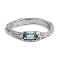 Handcrafted sterling silver ring with a 3 x 5mm baguette cut topaz set in an organic sculpted band made in Berlin.