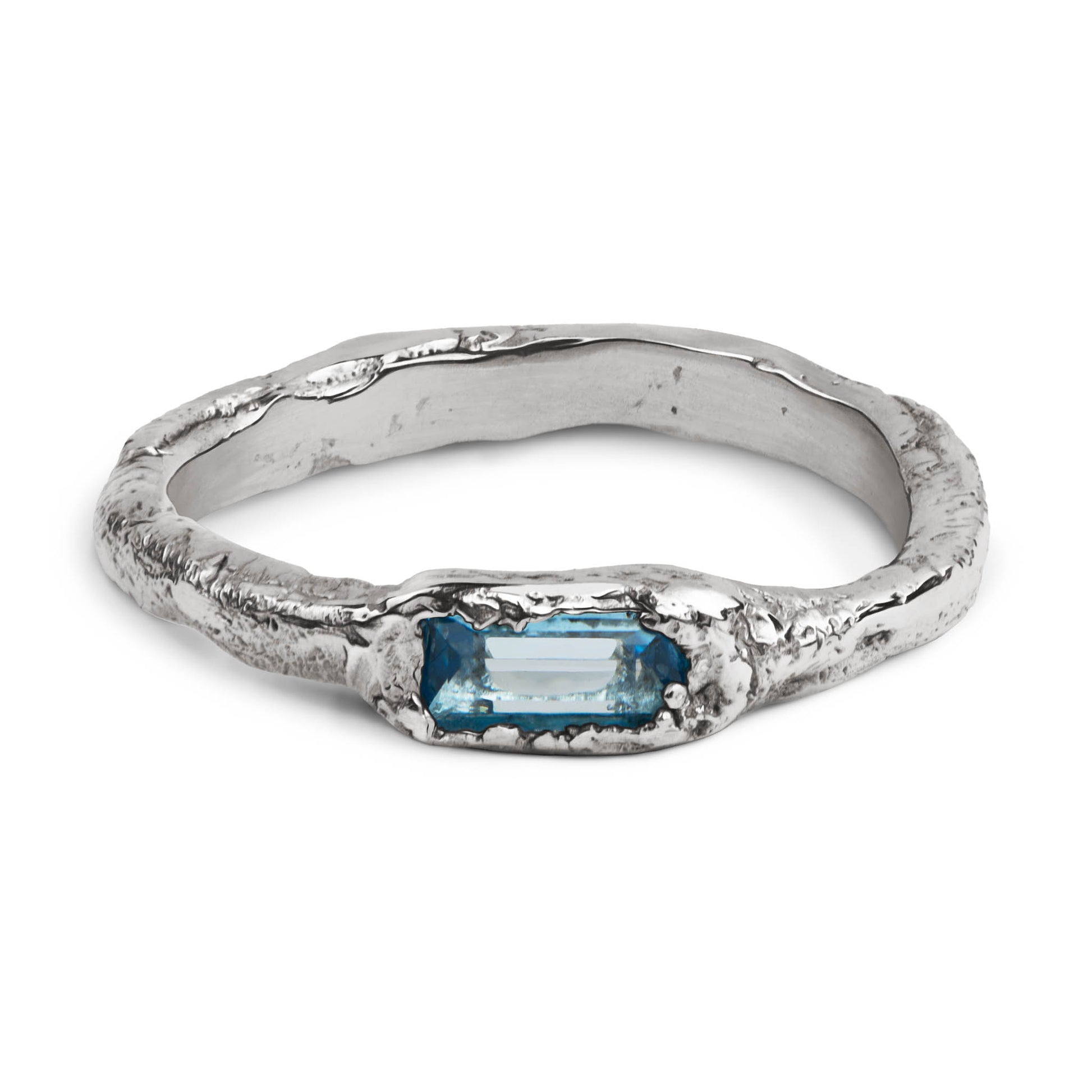 Handcrafted sterling silver ring with a 3 x 5mm baguette cut topaz set in an organic sculpted band made in Berlin.