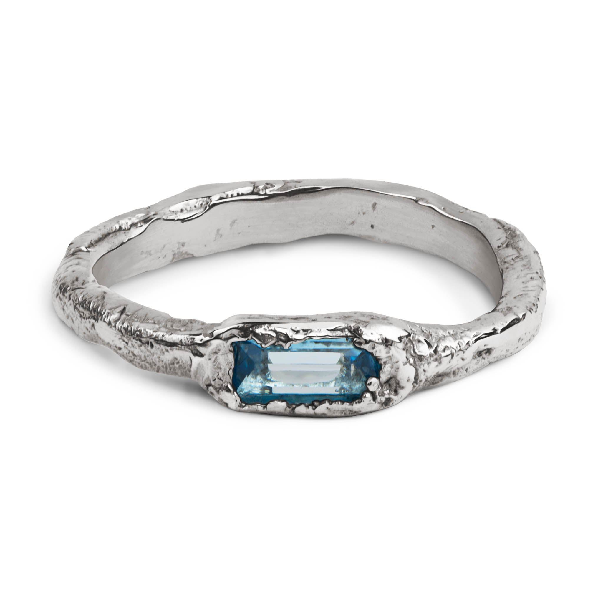 Handcrafted sterling silver ring with a 3 x 5mm baguette cut topaz set in an organic sculpted band made in Berlin.