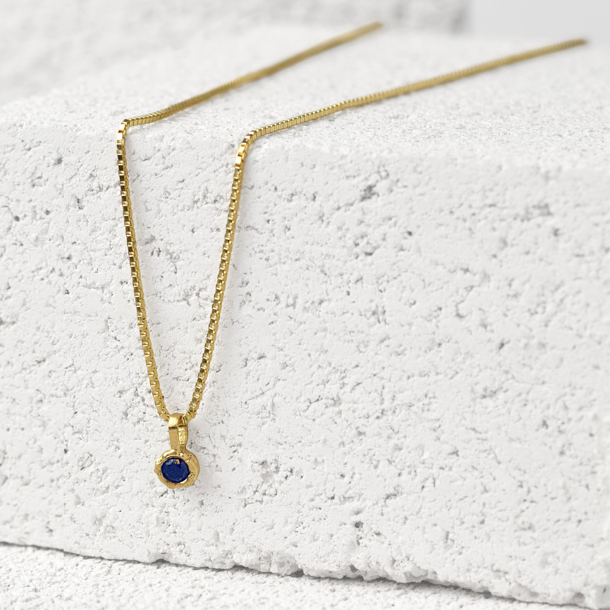 Gold Charm Necklace With Blue Sapphire