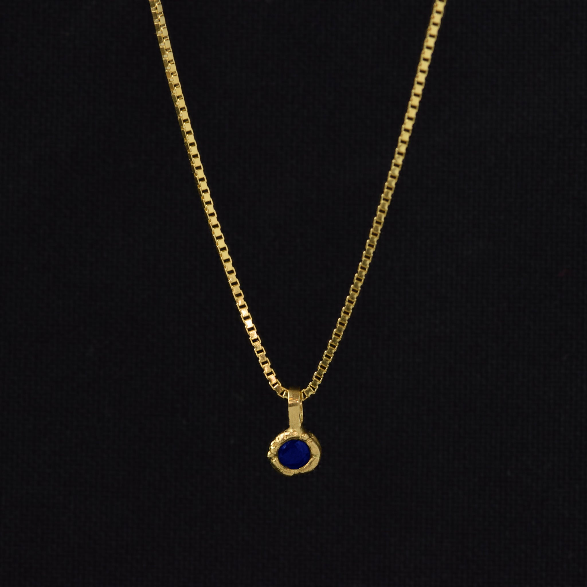 Gold Charm Necklace With Blue Sapphire