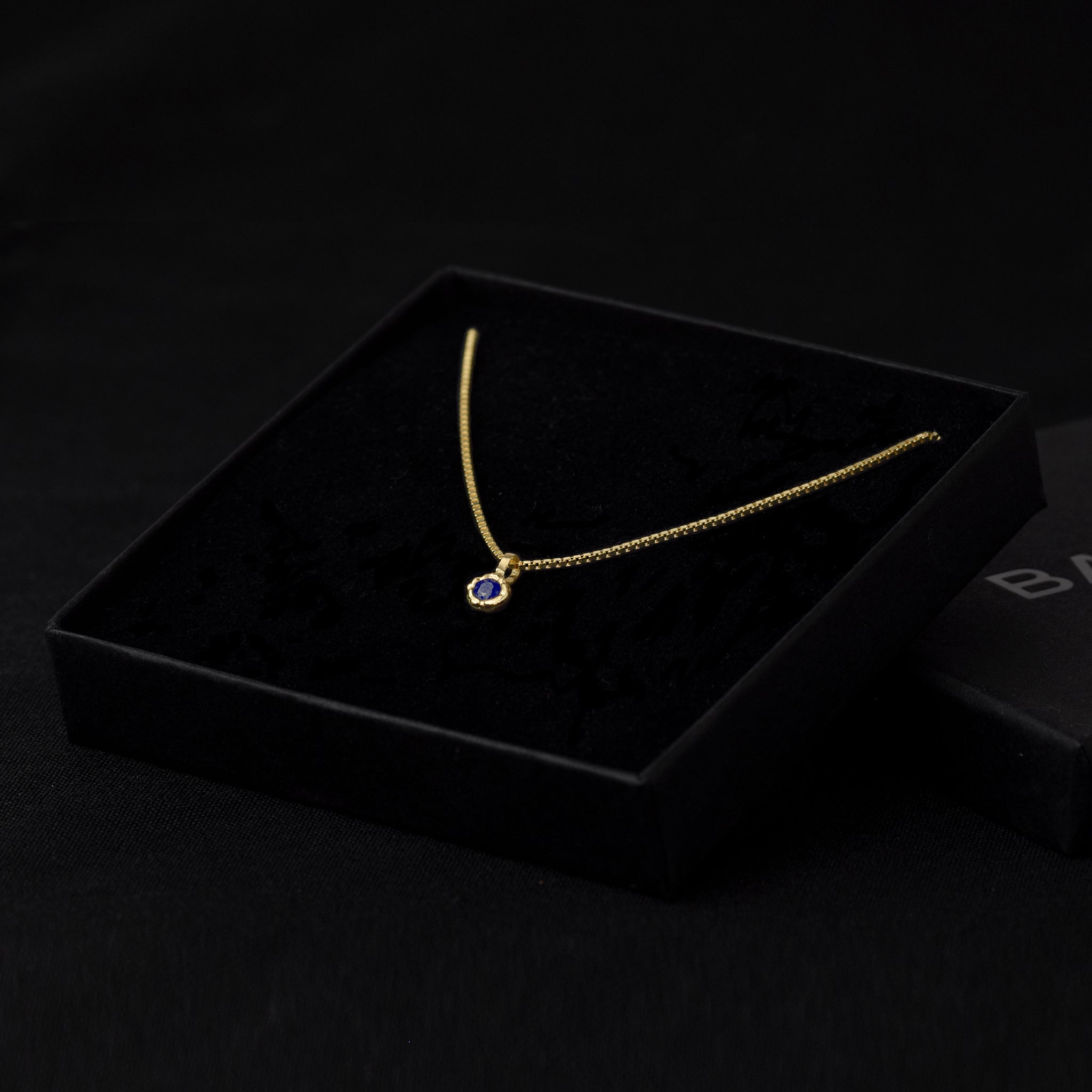 Gold Charm Necklace With Blue Sapphire