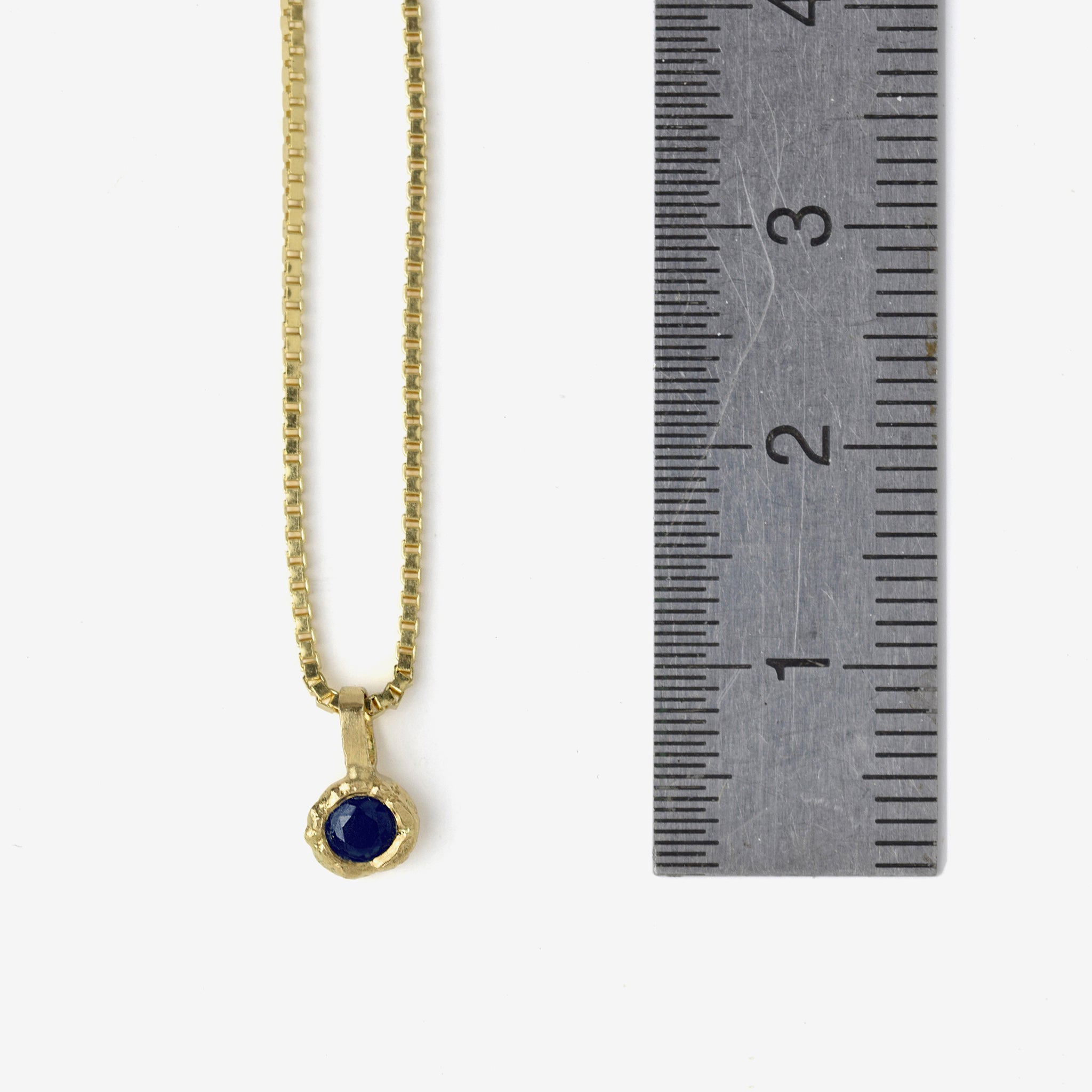 Gold Charm Necklace With Blue Sapphire