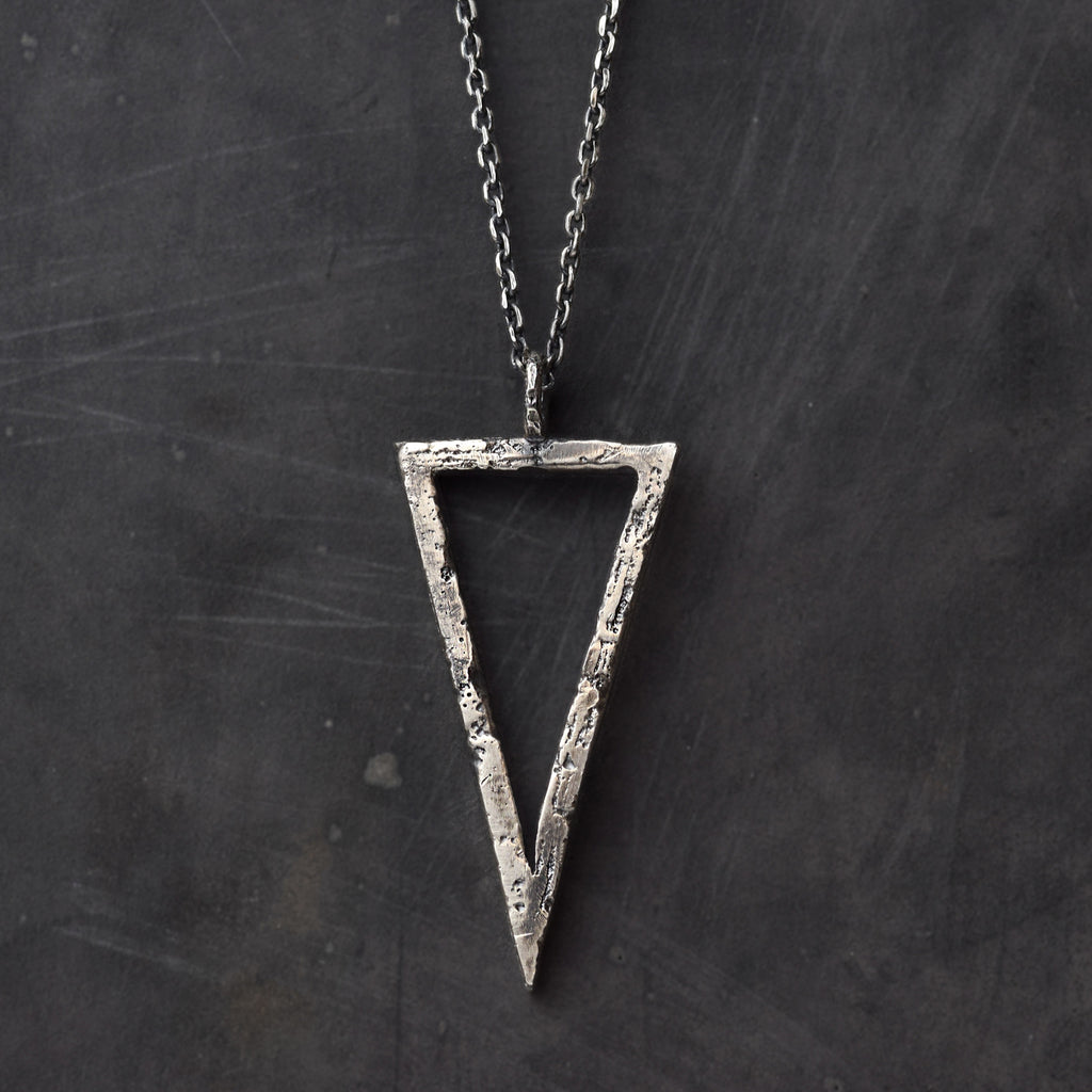 Handcrafted sterling silver triangle pendant necklace with an organic textured geometric design