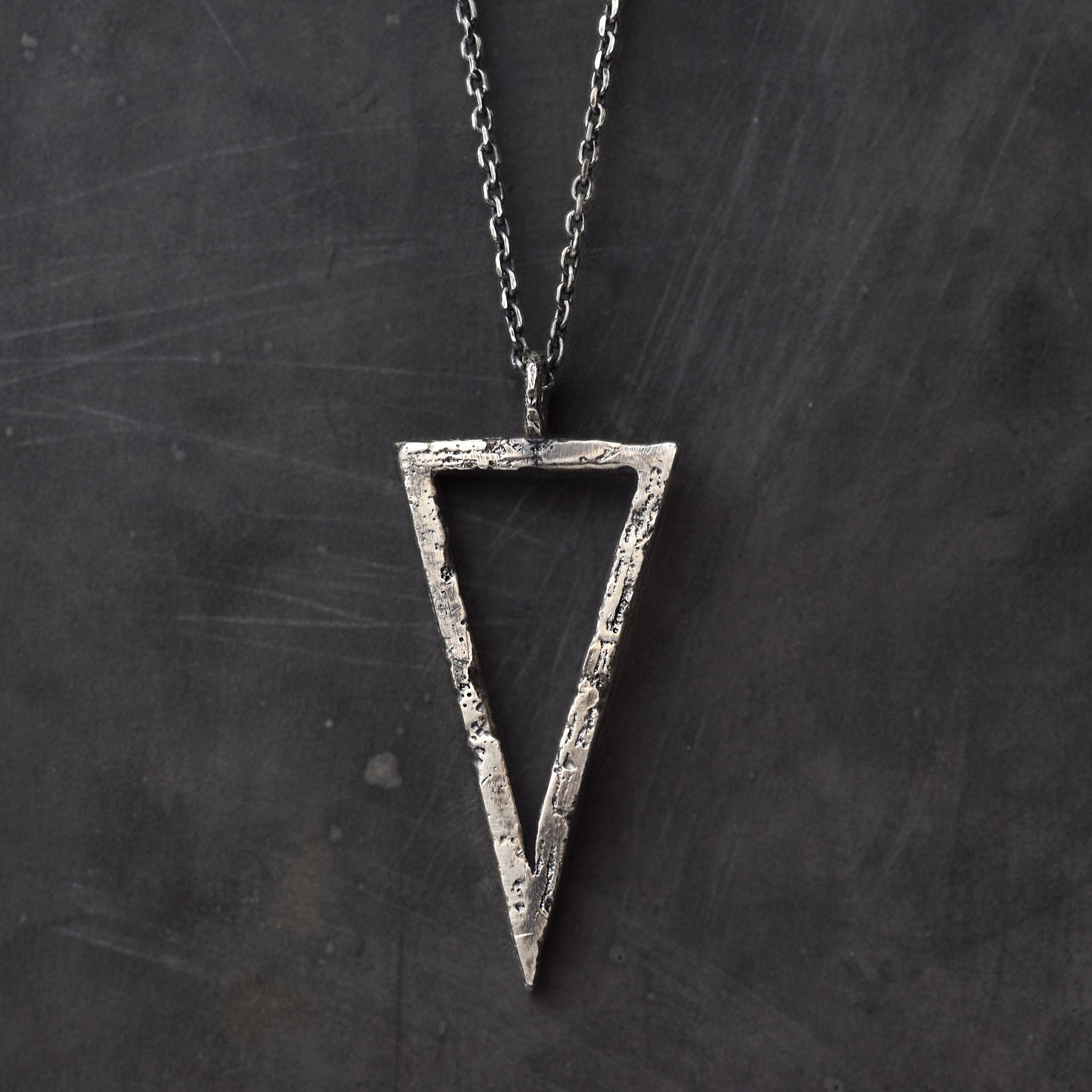 Handcrafted sterling silver triangle pendant necklace with an organic textured geometric design