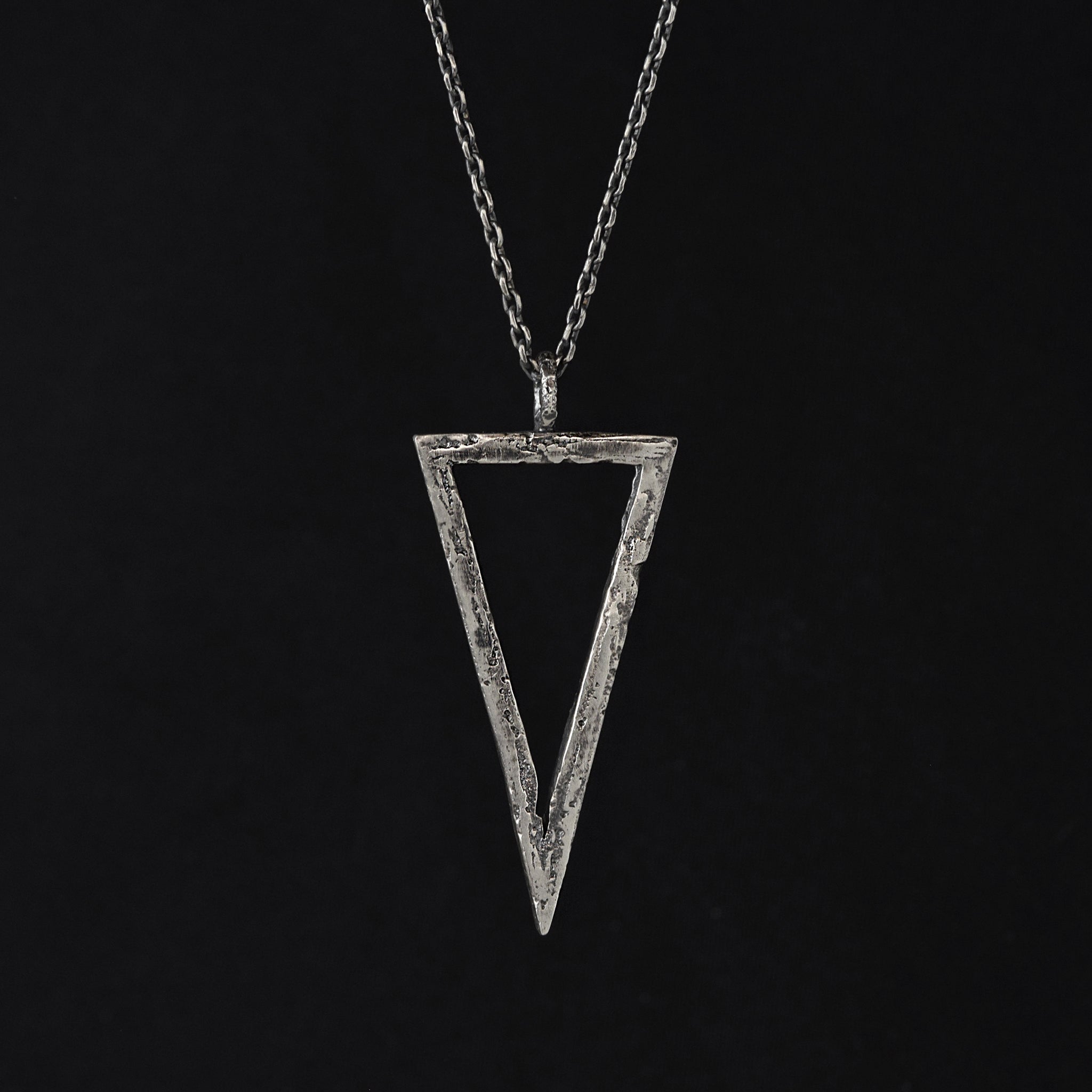 Handcrafted sterling silver triangle pendant necklace with an organic textured geometric design