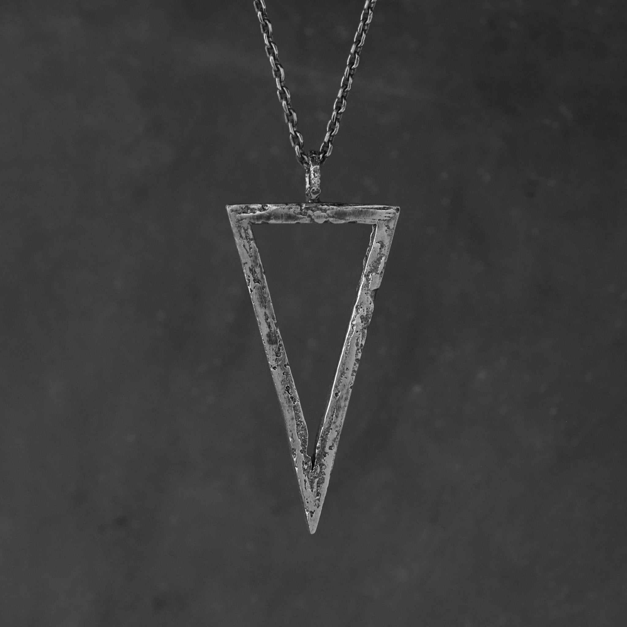 Handcrafted sterling silver triangle pendant necklace with an organic textured geometric design